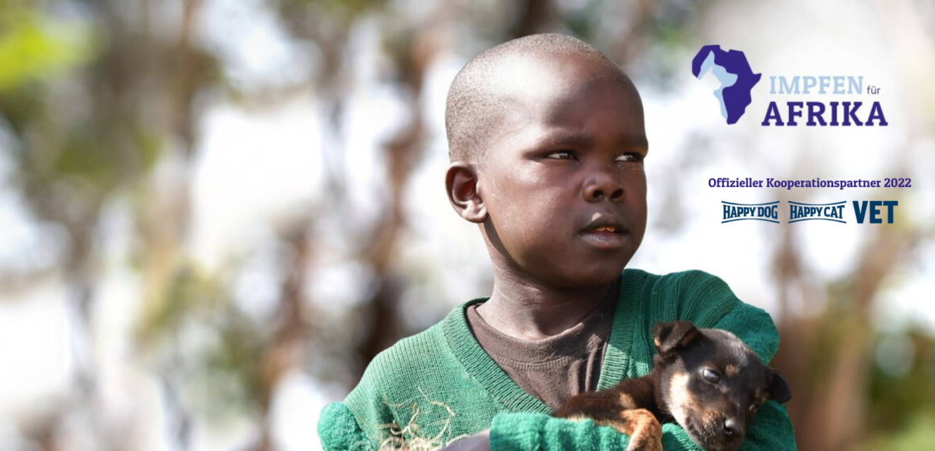 Junge mit Hund auf dem Arm - Werbung für Impfen für Afrika Kampagne. _W